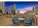 Rooftop terrace with chairs, tables, and city views at sunset at 860 Peachtree Ne St # 2815, Atlanta, GA 30308
