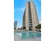 Outdoor pool with lounge chairs and view of the tall building in the city at 860 Peachtree Ne St # 2815, Atlanta, GA 30308
