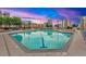 Outdoor pool with lounge chairs and city skyline views at dusk and lit buildings at 860 Peachtree Ne St # 2815, Atlanta, GA 30308