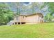 Side view of backyard with ample green grass and partially wooded area at 5326 Highway 5, Douglasville, GA 30135