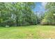 Large open backyard space surrounded by beautiful trees at 5326 Highway 5, Douglasville, GA 30135