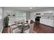 Elegant dining area with a glass table set near an open kitchen, perfect for Gathering gatherings at 5326 Highway 5, Douglasville, GA 30135