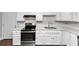 Well-equipped kitchen with stainless steel appliances, ample counter space, and sleek white cabinets at 5326 Highway 5, Douglasville, GA 30135