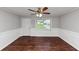 Bright living room showcasing hardwood floors, fresh white trim, and an updated ceiling fan at 5326 Highway 5, Douglasville, GA 30135