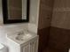 Updated bathroom with a stylish vanity, a mirror, and a tiled shower, offering a modern touch at 1297 Cahaba Dr, Atlanta, GA 30311