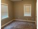Serene bedroom with neutral walls, plush carpeting, and abundant natural light from two windows at 1297 Cahaba Dr, Atlanta, GA 30311