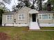 Charming single-Gathering home with neutral siding, black front door, and white trim on a well-maintained lawn at 1297 Cahaba Dr, Atlanta, GA 30311