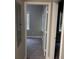 Hallway view to bedrooms with neutral walls and new carpet, offering a peek into other living spaces at 1297 Cahaba Dr, Atlanta, GA 30311