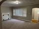 Inviting living room featuring neutral paint, new carpeting, a decorative fireplace, and ample natural light at 1297 Cahaba Dr, Atlanta, GA 30311