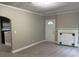 Cozy living room features fresh carpeting, a fireplace, and a doorway, offering a warm and welcoming atmosphere at 1297 Cahaba Dr, Atlanta, GA 30311
