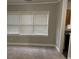 Living room with large windows, neutral paint, and new carpeting leading into the kitchen at 1297 Cahaba Dr, Atlanta, GA 30311