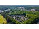 An aerial view showcases a lovely neighborhood surrounded by lush greenery and a golf course nearby at 265 Trecastle Sq, Canton, GA 30114