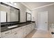 Bathroom featuring double sinks, granite countertops, stylish mirrors, and plenty of storage space at 265 Trecastle Sq, Canton, GA 30114