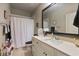 Bathroom featuring a vanity with a single sink, framed mirror, and a shower/tub combination with a white curtain at 265 Trecastle Sq, Canton, GA 30114