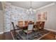 Spacious dining room features a chandelier, stylish accent wall, and hardwood floors at 265 Trecastle Sq, Canton, GA 30114