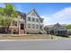 Attractive townhome exteriors feature brick and siding accents, complemented by manicured landscaping, and beautiful architectural details at 265 Trecastle Sq, Canton, GA 30114