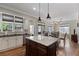 Open kitchen featuring a large island, hardwood floors, stainless appliances, and natural light at 265 Trecastle Sq, Canton, GA 30114