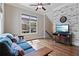 Cozy living room featuring hardwood floors, a comfortable sofa, and natural light from a large window at 265 Trecastle Sq, Canton, GA 30114