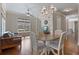 Open-concept living and dining area with hardwood floors, a brick accent wall, and natural light at 265 Trecastle Sq, Canton, GA 30114