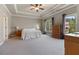 Spacious main bedroom with tray ceiling, neutral walls, carpet flooring, and natural light from two large windows at 265 Trecastle Sq, Canton, GA 30114