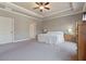Bright main bedroom with a tray ceiling, carpet, neutral colors, and white trim for a serene retreat at 265 Trecastle Sq, Canton, GA 30114