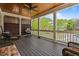 Spacious outdoor porch with a ceiling fan, comfortable seating, and a view of the neighborhood at 265 Trecastle Sq, Canton, GA 30114