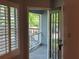 Charming balcony view with natural light streaming through shuttered windows and a glass paned door at 4828 Westridge Dr, Norcross, GA 30093