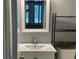 This bathroom features a clean white vanity and sink with stylish shelving for storage at 4828 Westridge Dr, Norcross, GA 30093