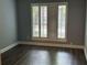 Bright bedroom with large windows featuring wooden shutters and dark wood-look floors at 4828 Westridge Dr, Norcross, GA 30093