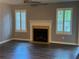Bright living room with a cozy fireplace, plantation shutters, and a modern ceiling fan at 4828 Westridge Dr, Norcross, GA 30093