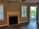 Inviting living room features a fireplace, plantation shutters, and opens to an outdoor deck at 4828 Westridge Dr, Norcross, GA 30093