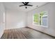 Bright bedroom featuring luxury vinyl plank flooring, a ceiling fan, and a large window at 551 Lake Dr, Atlanta, GA 30354