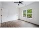 Bright bedroom featuring luxury vinyl plank flooring, a ceiling fan, and a large window at 551 Lake Dr, Atlanta, GA 30354