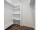 Walk-in closet with built-in shelving and modern luxury vinyl plank flooring at 551 Lake Dr, Atlanta, GA 30354