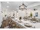 Dining room with seating for eight, modern chandelier, and open concept with kitchen and living room at 551 Lake Dr, Atlanta, GA 30354