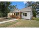 Quaint single-Gathering home featuring a cozy porch with wooden posts, and a well manicured front yard with a sidewalk at 551 Lake Dr, Atlanta, GA 30354
