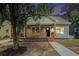 Charming home with a welcoming front porch with wood trim, well-maintained landscaping, and a cozy curb appeal at 551 Lake Dr, Atlanta, GA 30354