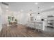 Spacious open-concept kitchen with stainless steel appliances and island with seating that flows into the dining area at 551 Lake Dr, Atlanta, GA 30354