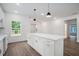 Modern kitchen featuring a white island with pendant lighting and an open layout at 551 Lake Dr, Atlanta, GA 30354