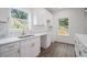 Bright kitchen boasts white cabinets, brass fixtures, and marble countertops at 551 Lake Dr, Atlanta, GA 30354