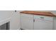 Functional laundry area with a butcher block countertop and white cabinets at 551 Lake Dr, Atlanta, GA 30354