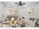 Bright and airy living room featuring neutral tones, recessed lighting, and open access to the kitchen and dining areas at 551 Lake Dr, Atlanta, GA 30354
