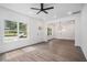 Bright living room with large windows, recessed lights, and an open layout with a dining area featuring dark, wood-look floors at 551 Lake Dr, Atlanta, GA 30354