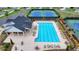 Aerial view of community pool, tennis courts and clubhouse surrounded by well maintained landscaping at 5650 Bergeson Ways, Cumming, GA 30028