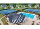 Aerial view of community pool, tennis courts and clubhouse surrounded by well maintained landscaping at 5650 Bergeson Ways, Cumming, GA 30028