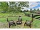 Backyard features a fire pit with chairs and a beautiful tree line at 5650 Bergeson Ways, Cumming, GA 30028