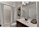 Bathroom with framed mirror, vanity, toilet, and shower-tub combination at 5650 Bergeson Ways, Cumming, GA 30028