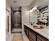 Bathroom with double sink vanity, a large mirror, and a glass-enclosed tiled shower at 5650 Bergeson Ways, Cumming, GA 30028