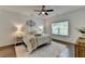 Bright bedroom with a ceiling fan, decorative wall art, and dark hardwood floors at 5650 Bergeson Ways, Cumming, GA 30028