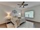 Bright bedroom with a ceiling fan, decorative wall art, and dark hardwood floors at 5650 Bergeson Ways, Cumming, GA 30028